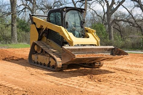 grading a slope with a skid steer|grading driveway with skid steer.